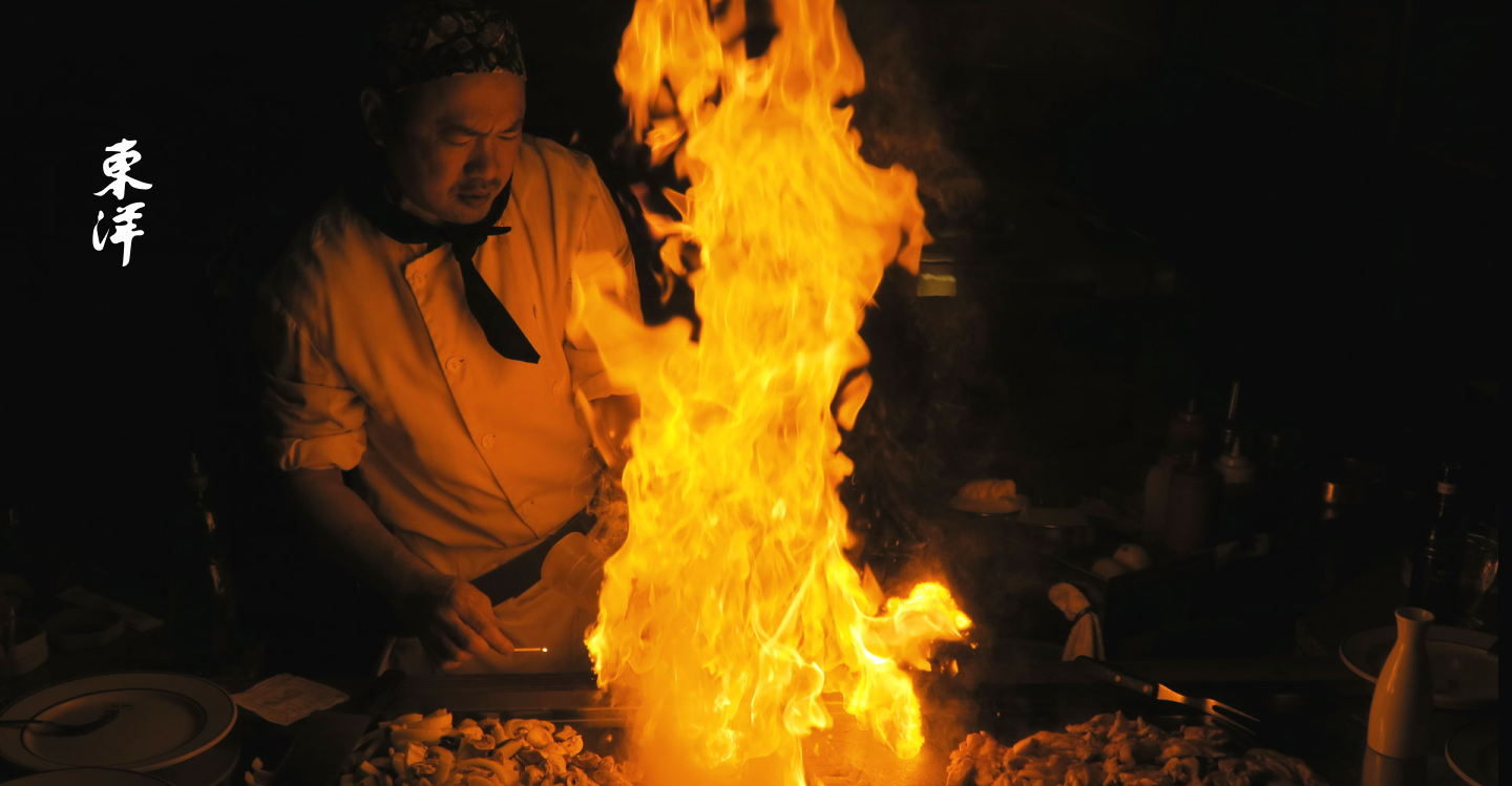 Toyo Chef cooking in the hibachi with a big fire